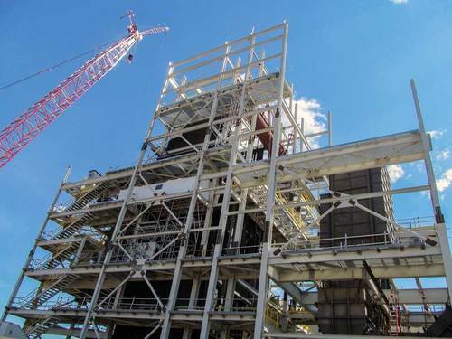 Heavy industrial boiler structure with a robust steel framework for high-pressure systems.